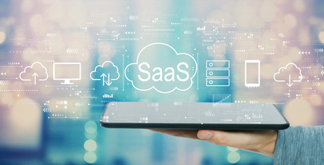 SaaS - software as a service concept with man holding a tablet computer