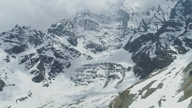 Stunning sky-high ridge of Annapurna III mountain, cloud shadows on glacier snow