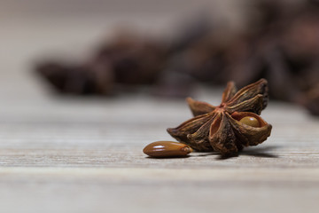 star anise with or without seed, closed, on a light wooden surface. spice for the recipe. beautiful picture, background.