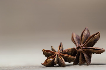 star anise with or without seed, closed, on a light wooden surface. spice for the recipe. beautiful picture, background.