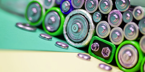 Many different types used or new battery, rechargeable accumulator, alkaline batteries on color...