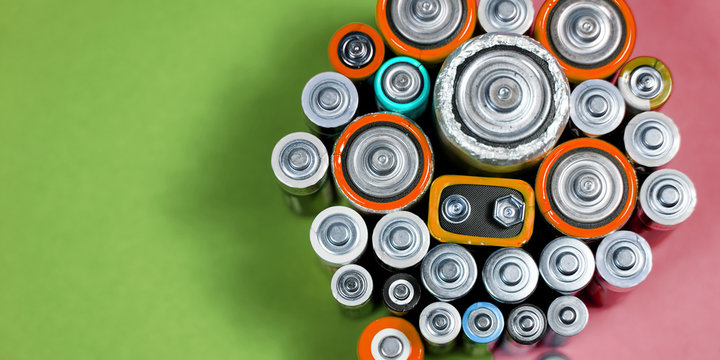 Many different types used or new battery, rechargeable accumulator, alkaline batteries on color background.