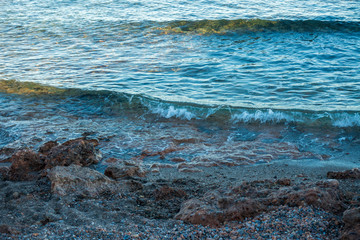 Calm waves on the shore of the blue sea