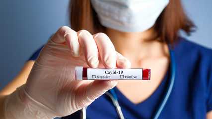 Nurse holding test tube with blood for Covid-19 test. Corona Virus Disease 2019 blood analyzing concept.