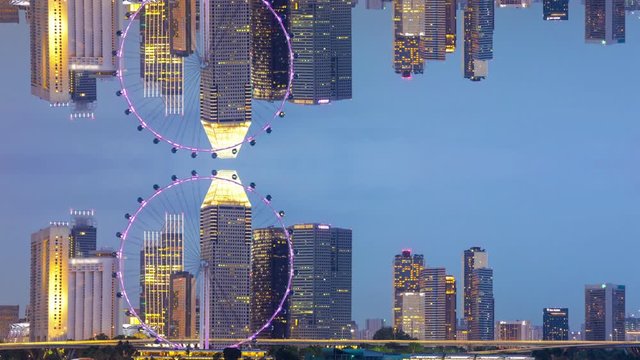 Time lapse of day to night of beautiful Singapore flyer and cityscape of Singapore with the mirror effect. Upside down inception theme. 