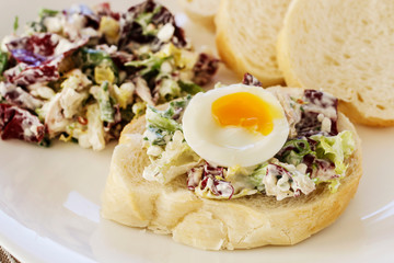 Sandwich with hard-boiled egg and vegetable salad.
