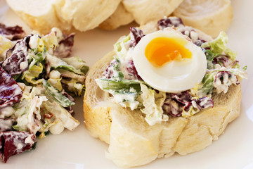 Sandwich with hard-boiled egg and vegetable salad.