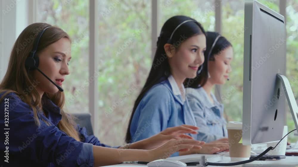Aufkleber customer support agent or call center with headset works on desktop computer while supporting the cu