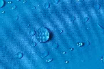 Water droplets on a  waterproof fabric blue background
