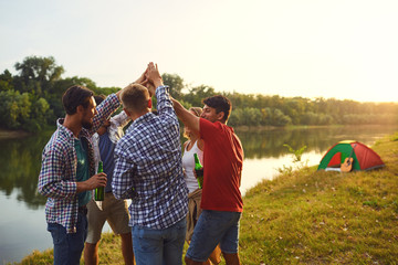 A group of people raised their hands up on a picnic