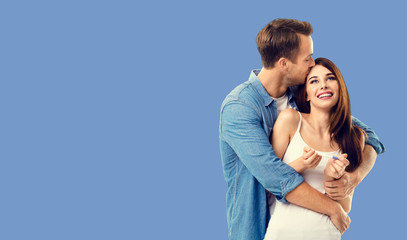 Love, new parents and family concept - very happy excited couple, finding out results of a pregnancy test. Blue color background. Copy space for some text.