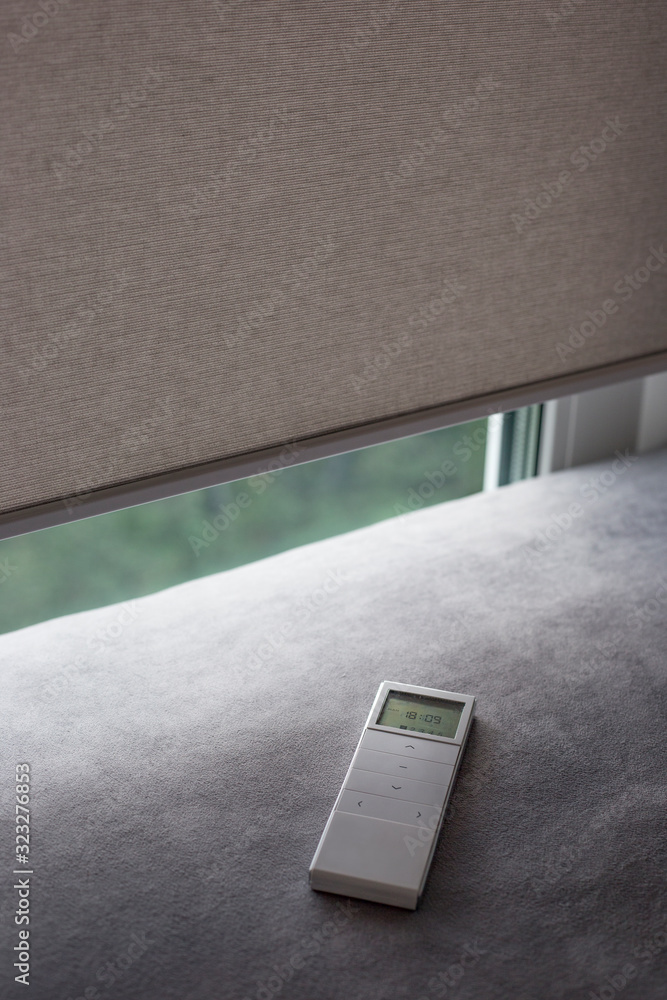 Aufkleber white remote control panel for motorized roller shades. automatic roller blinds beige color on the w
