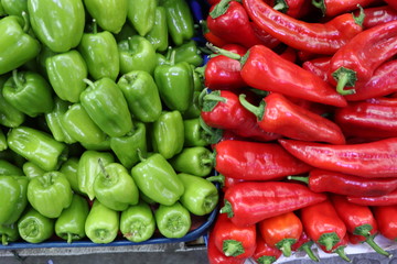 green peppers and red hot peppers on the market