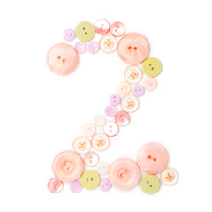 number 2 from pink and green buttons isolated on white. Sewing kit. Colorful button number two, stylish alphabet for handmaking hobby. Handmade sew abc. Text from buttons. Sale of sewing furniture