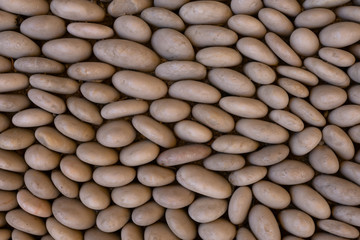 Layout with a lot of small ellipse stones with copy space. Top view of blank rocky wall as pattern.