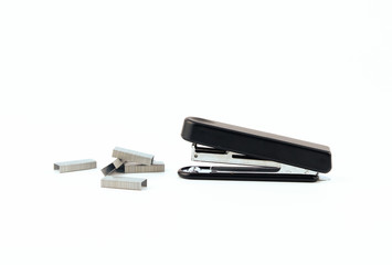 Black stapler and metal staple isolated on a white background. Office Equipment and Work Tool...