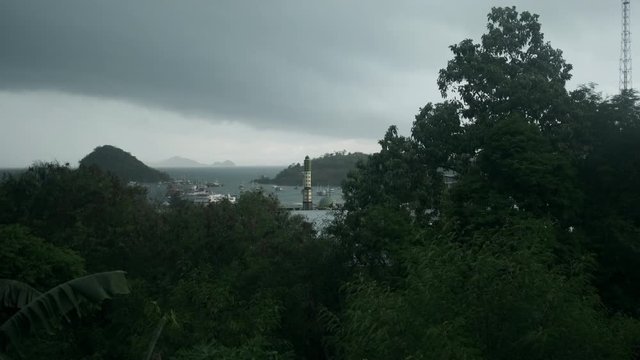 Cloudy wether landscape view shot of amazing harbor at muslim tropical island with jungles