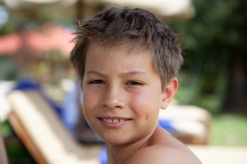 Boy outside looks into camera
