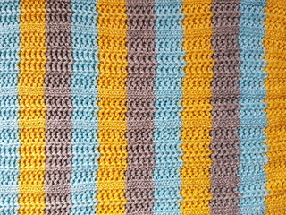 Striped fabric background. Blue, gray, yellow knitted stripes.