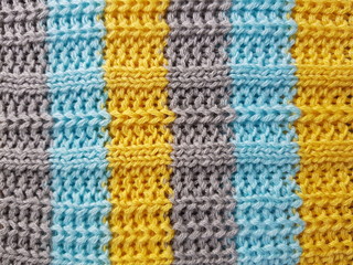 Fototapeta na wymiar Striped sweater background blue, gray, yellow stripes.