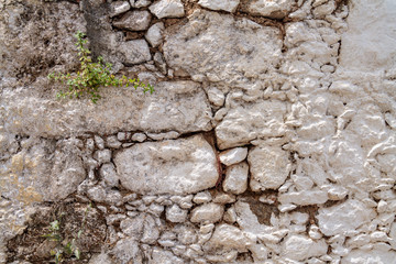 Stone medieval wall. Stones hold together by clay solution.