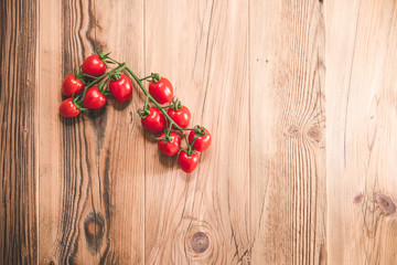 Fototapeta na wymiar Cherry tomatoes on wooden table, flat-lay
