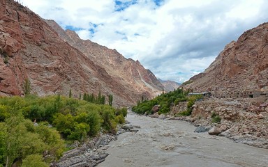 Indus river with bare mountains behind next to Leh, Ladakh