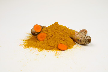 Turmeric powder and turmeric roots are isolated on a white background.It is used as a tonic for...