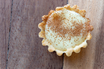 A close up view of a small homemade milk tart on a isolated background