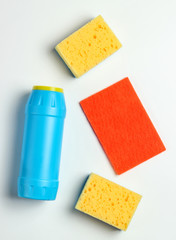 Cleaning concept. Detergent bottle, sponges on white background