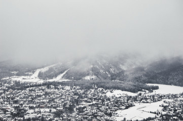 Landscape photo of mountains covered in snow on a misty winter day