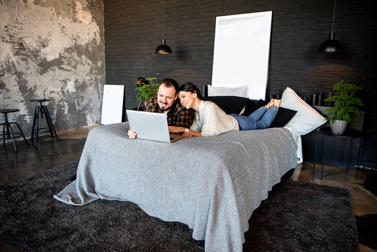 ?ouple watching movies at home on a laptop