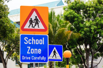 yellow color warning school zone traffic sign on road