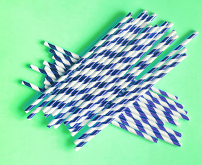 Top view of colorful paper disposable eco-friendly straws. Drinking straws with blue strips for...