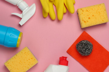 Set of products for cleaning the house on pink pastel background. Top view. Copy space
