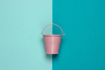 Pink empty mini bucket on blue pastel background. Minimalism. Trend color concept. Top view © splitov27