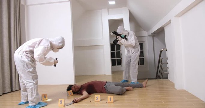 Criminological Expert Collecting Evidence At The Crime Scene