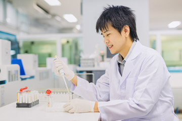 Medical doctor or health sciences professional working for analyzing blood samples in laboratory of scientific research. Concept for biology chemistry and medical technology scienctist.
