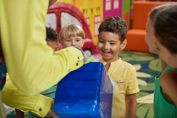 Scientific show for kids. Happy kids having fun in playroom. Positive emotions and facial...
