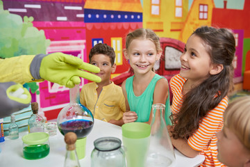 Scientific show on kids Birthday party. Excited kids watching science experiment. Childrens...