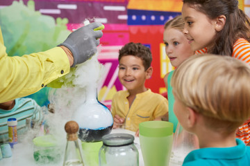 Liquid nitrogen show for kids. Chemical show program for children. Happy kids in amusement park...