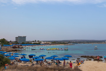 Fototapeta na wymiar Ayia Napa, Cyprus - September 08, 2019: People are swimming on Makronissos Beach