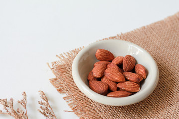almond seeds in bowl with copy space for product or text.