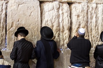 man and woman in front of Western wall in Jerusalem 