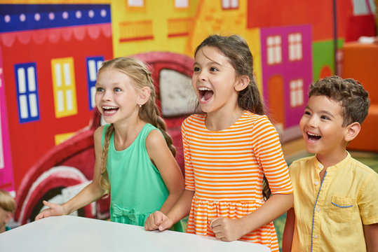 Three emotional kids in playroom. Show kids Birthday party. Fun learning activities for kids.