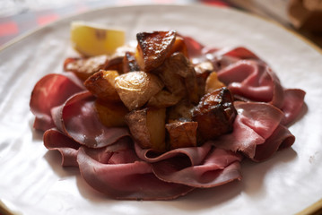 Roast beef slices with roasted potatoes