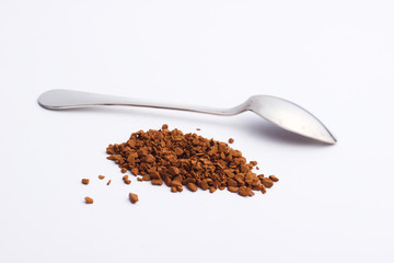 Metal spoon with granulated coffee on a white background