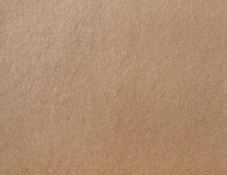 Kraft wrapping paper texture. Photo of brown cardboard background.