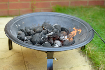 bbq grill charcoal starting fire for party in backyard in england uk