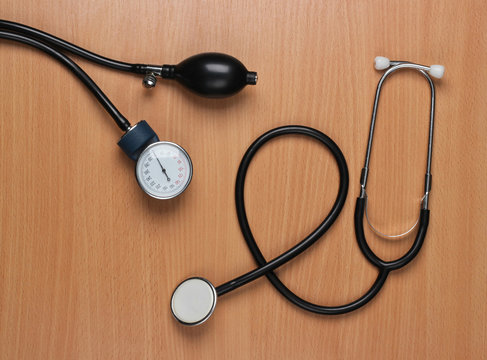 Workspace of a doctor. Stethoscope and monometer on the office desk